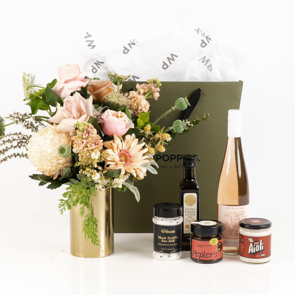 "New Home Gift Hamper" showcasing a selection of gourmet treats including truffle sea salt, Jules Rose wine, olive oil, aioli, and chutney, paired with a beautiful fresh pastel posy. Thoughtfully presented in a premium Wild Poppies gift box, perfect for celebrating a fresh start in a new home.