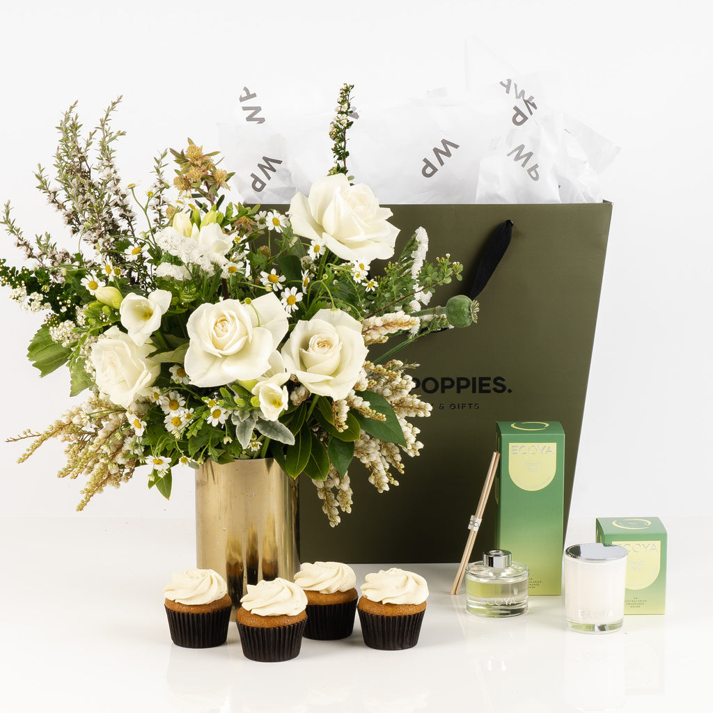 Elegant "Pear and Vanilla Dream Combo Gift" featuring a white and green posy, Ecoya French Pear scented candle and diffuser, and four vanilla petal cupcakes. Beautifully presented in a premium Wild Poppies gift bag with satin ribbon, creating a luxurious, fragrant experience for any occasion.